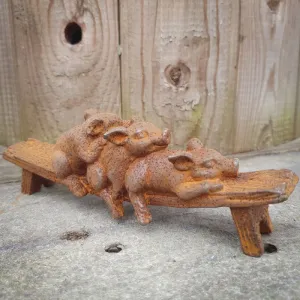 Cast Iron Pigs on Bench